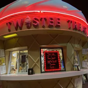 an ice cream cone with a neon sign