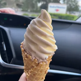 Butterscotch dipped swirl chocolate and vanilla chocolate and nut waffle cone