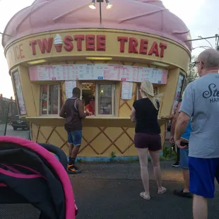 people standing in front of an ice cream shop