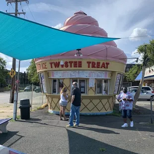 people standing in front of an ice cream shop