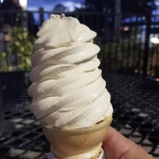 a hand holding an ice cream cone