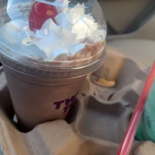 a drink with whipped cream and a cherry