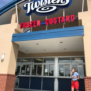 a woman standing in front of a store