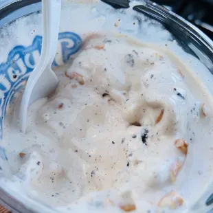 a hand holding a cup of ice cream