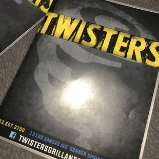 two posters for twisters grill and bar