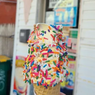 Small twist cone dipped in rainbow sprinkles