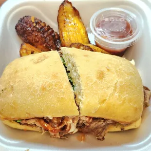 Twisted Roots sandwich with a side of plantains, $16. It&apos;s messy but very flavorful.