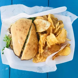 Surf N&apos; Turf sandwich with chips and drink