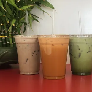 three different drinks on a table