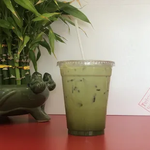 a green drink in a plastic cup
