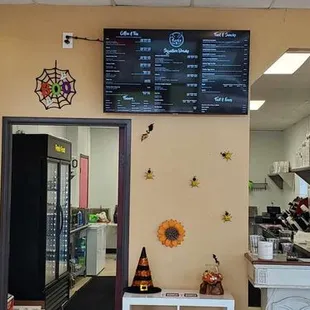 a coffee shop with a menu on the wall