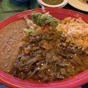 Crane Carne Guisada plate good taste but little meat lots of onions and peppers.
