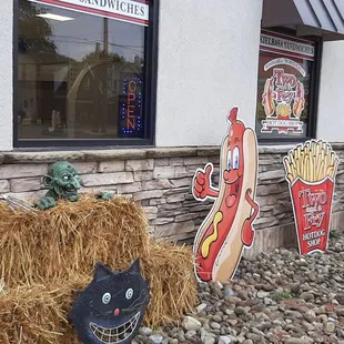 a skeleton sitting on a hay bale