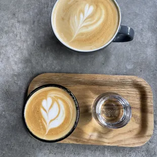 Oat milk cortado (bottom), whole milk latte (top)