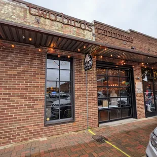 Outside. Storefront. Free street parking. Otherwise, there are pay lots nearby.