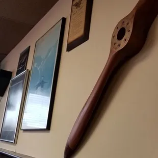 a large wooden baseball bat hanging on the wall