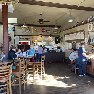 Entry looking at cash register, menu and dining.