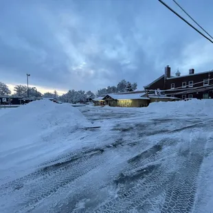 a snowy street in a residential area