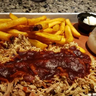 a tray of pulled pork and french fries