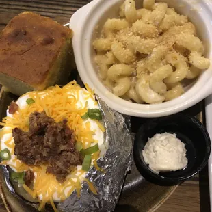 a plate of food with bread and a bowl of macaroni and cheese