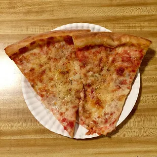 two slices of pizza on a paper plate
