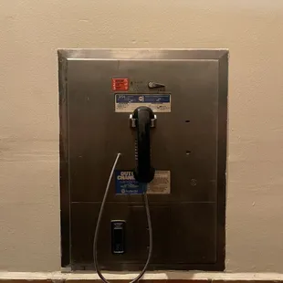 Old school pay phone by the bathroom