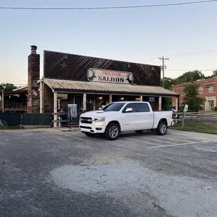 a pickup truck parked in front of a restaurant