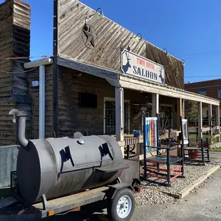 a bbq on a trailer in front of a building