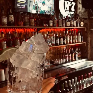 a person holding a glass of ice