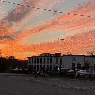 a sunset over a parking lot