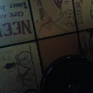 a toilet with graffiti on the walls