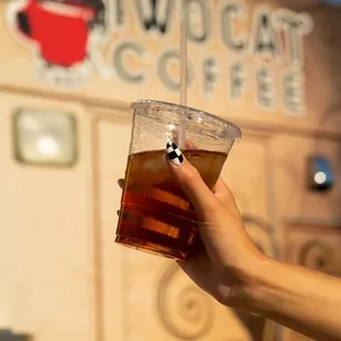 a hand holding a cup of coffee