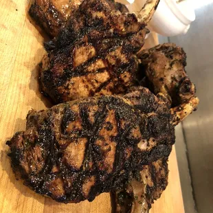 two grilled lambs on a cutting board