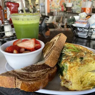 Under The Sea Omelet with added mushroom and spinach plus fruit bowl and rye toast on the side.  Also with Green Blast Cold Pressed Juice