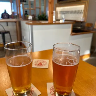 two glasses of beer on a table