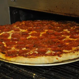 a pepperoni pizza in an oven
