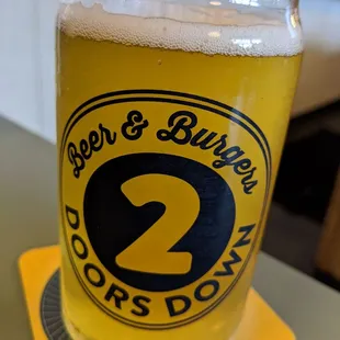 a glass of beer on a coaster