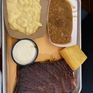 Spice Rubbed Pork Ribs w/ Mac and Cheese, Baked Beans and a piece of cornbread.