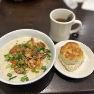 Shrimp &amp; grits with a biscuit and hot tea.