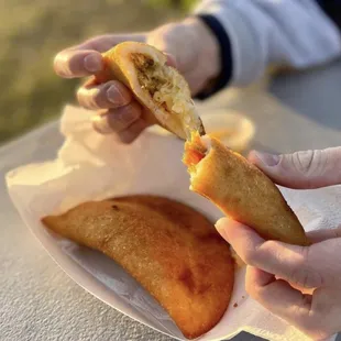 a person holding a piece of food