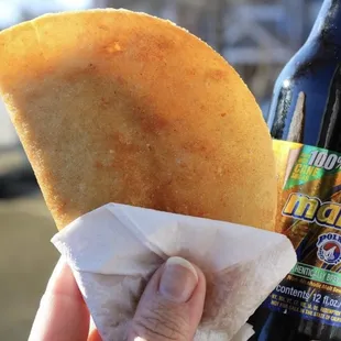 a person holding a bottle of beer