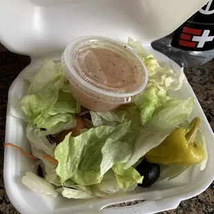 a salad in a styrofoam container