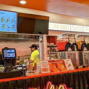  a man standing at the counter of a fast food restaurant