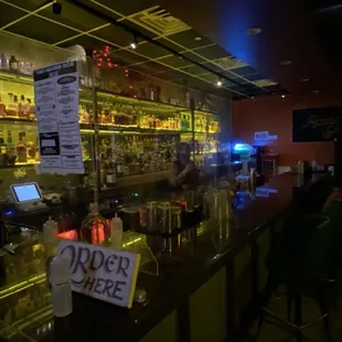 a bar with a menu on the counter