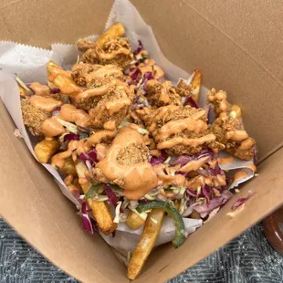 Loaded MotherCluckers- Seasoned fries slaw chicken nugget and saucy sauce.