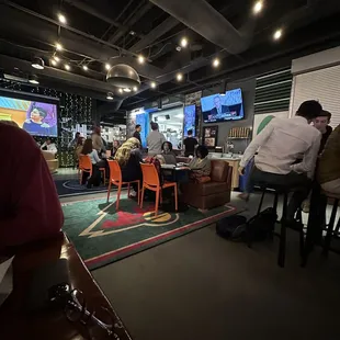 people sitting at tables in a restaurant