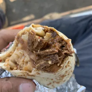 a person holding a burrito