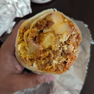 The super breakfast burrito is awesome!  It has chorizo, bacon, ham, potatoes, and cheese. $13