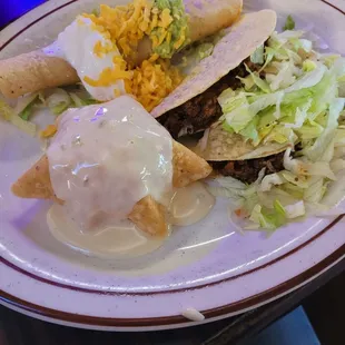 Combo Plate (two tacos, flauta, cheese puff, guacamole, &amp; sour cream)