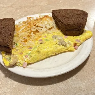 Three egg Supreme Omellett with hash browns and rye toast